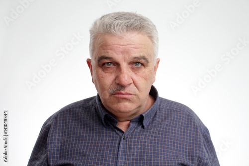 Portrait of a senior man with half mustache