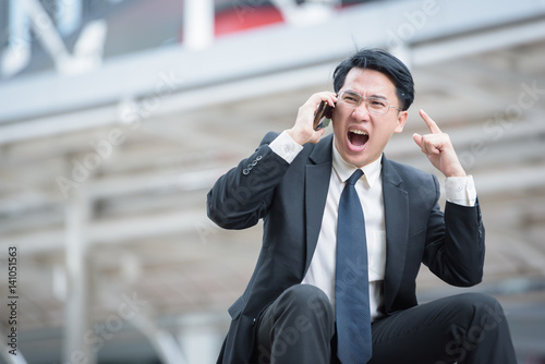 handsome caucasian businessman talking phone amazed