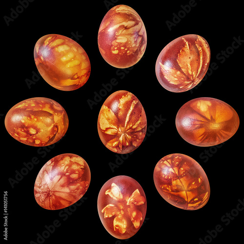 Nine Red Easter Eggs Onion Skin Dyed and Decorated with Leaves Imprints Isolated on Black Background
