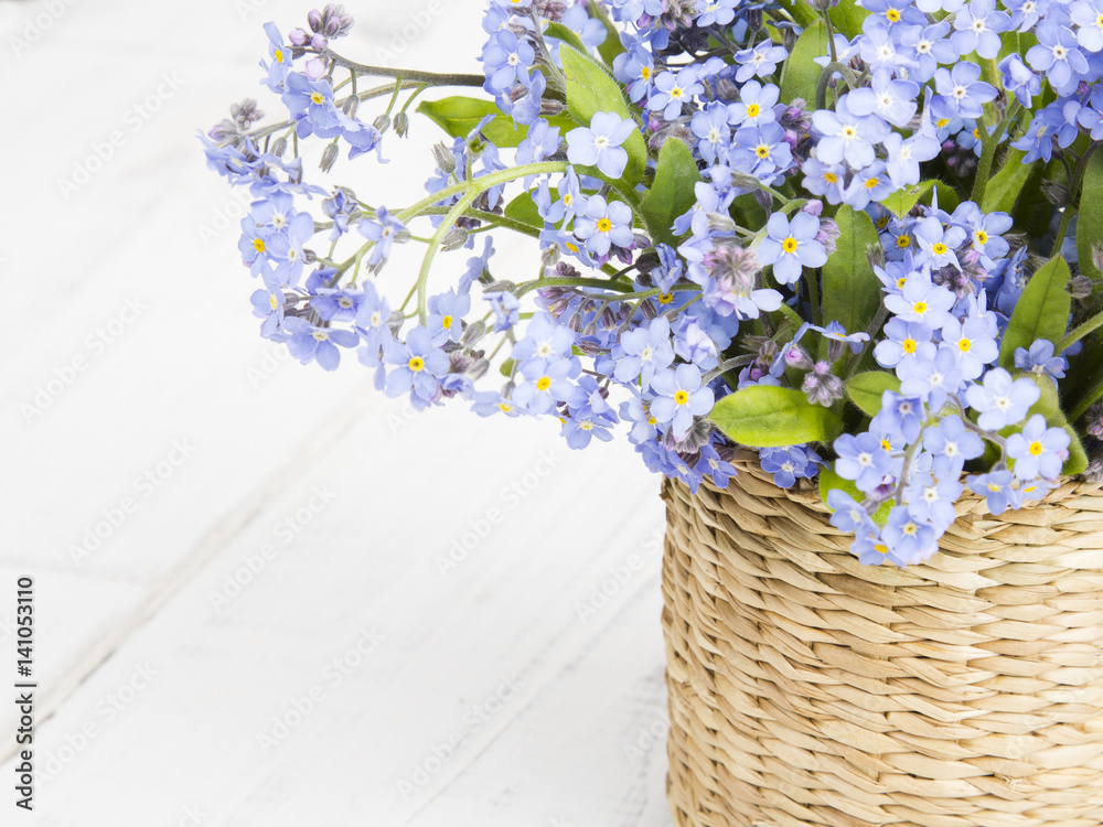 blue flowers bouquet on white wooden background