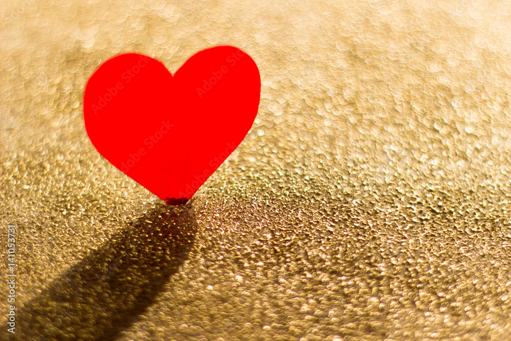 Fototapeta premium Cardboard heart on a gold background, abstract