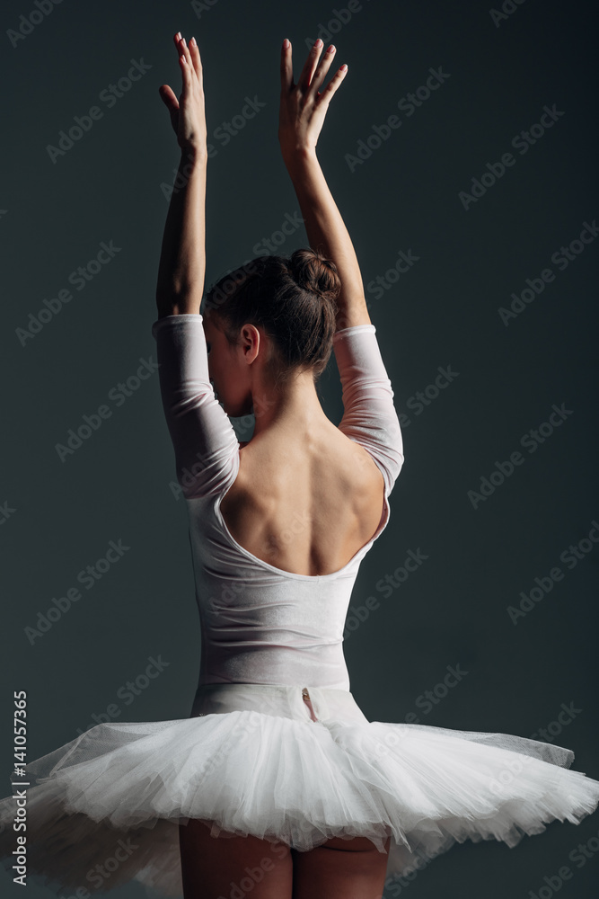 Fototapeta premium Young beautiful ballerina posing in studio