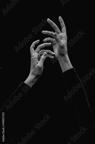 Cutel ballerinas hands on a black background