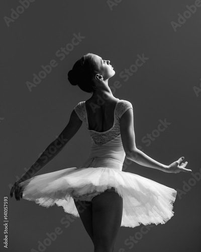 Obraz na plátně Young beautiful ballerina posing in studio