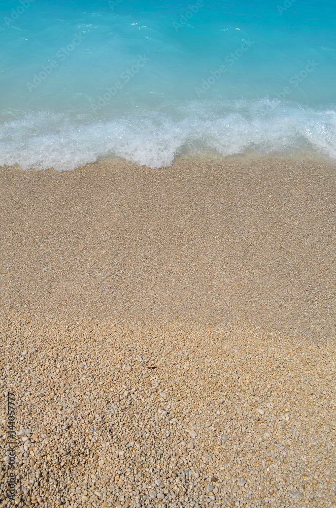 white and blue wave of blue ocean on sandy beach. Background. white and blue wave of blue ocean on sandy beach. Background.