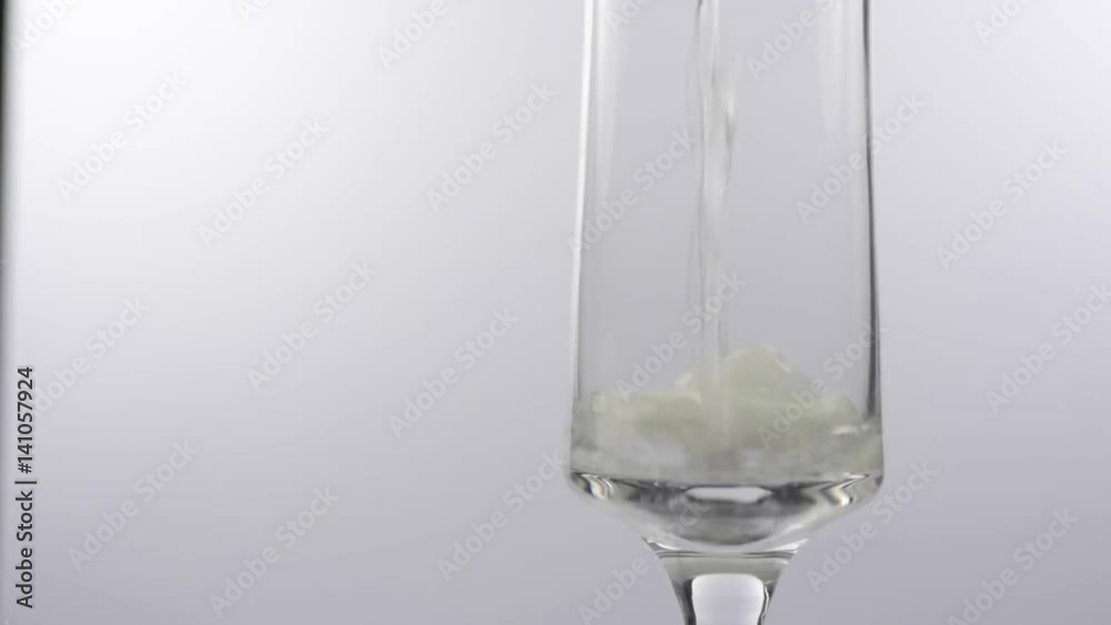 Slow motion Sparkling white wine poured into a glass Slow motion Sparkling white wine poured into a glass