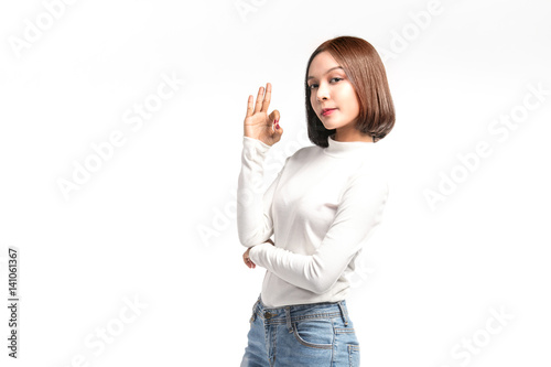 Beautiful asian girl making OK sign on white background