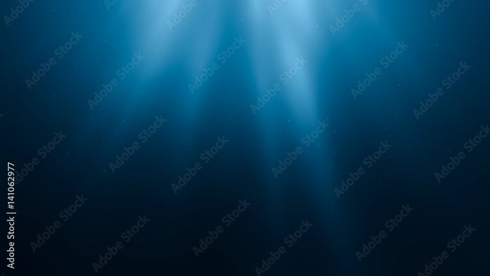 Sunlight rays shining through ocean surface. View from underwater. 3D rendered seamless loop animation.