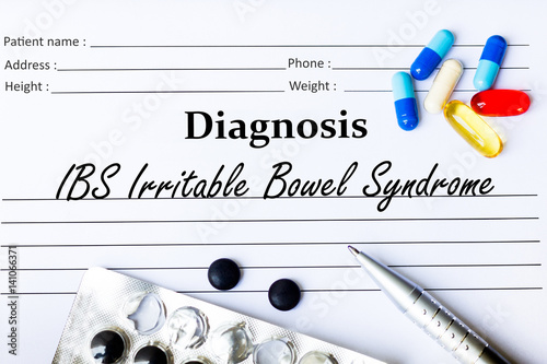 IBS Irritable Bowel Syndrome - Diagnosis written on a piece of white paper with medication and Pills