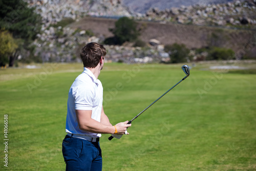 Young golfer getting ready on a golf course to play a round of golf