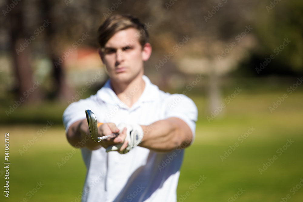Young golfer getting ready on a golf course to play a round of golf Young golfer getting ready on a golf course to play a round of golf