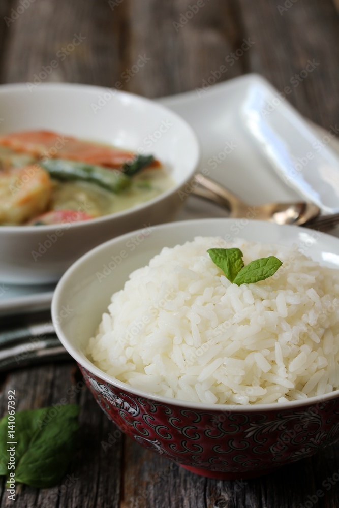 Thai jasmine rice served with Shrimp green curry sauce, selective focus Thai jasmine rice served with Shrimp green curry sauce, selective focus