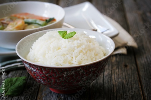 Thai jasmine rice served with Shrimp green curry sauce, selective focus