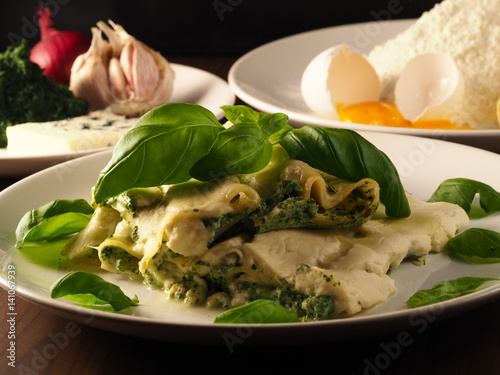 Cannelloni con ricotta e spinaci. Italian pasta with ricotta and spinach, basil, blue cheese, egg, flour, onion and garlic. Delicious food.