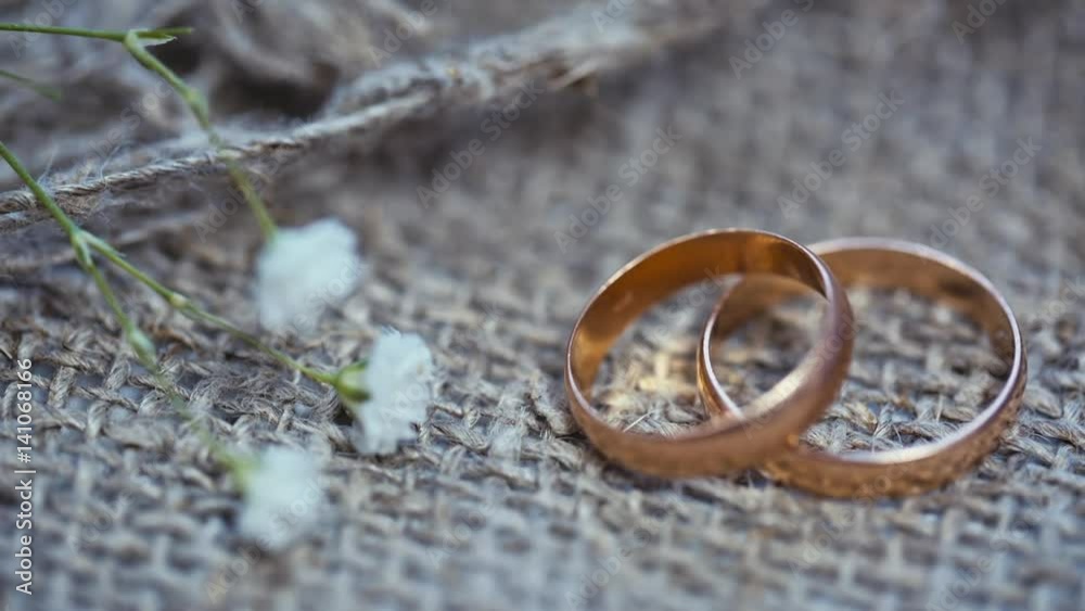 wedding rings and flowers on a linen background. wedding rings and flowers on a linen background.