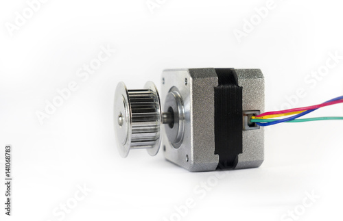 Electric stepper motor with a shiny metal timing pulley mounted to the shaft is laying down on its side ready to be used in a mechanical engineering or hobby robotics project.