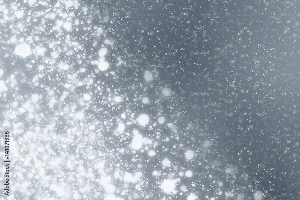 Snowflakes rays and bokeh or glitter lights on silver background. Christmas abstract template