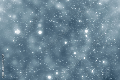 Snowflakes particles and bokeh or glitter lights on silver background. Christmas abstract template
