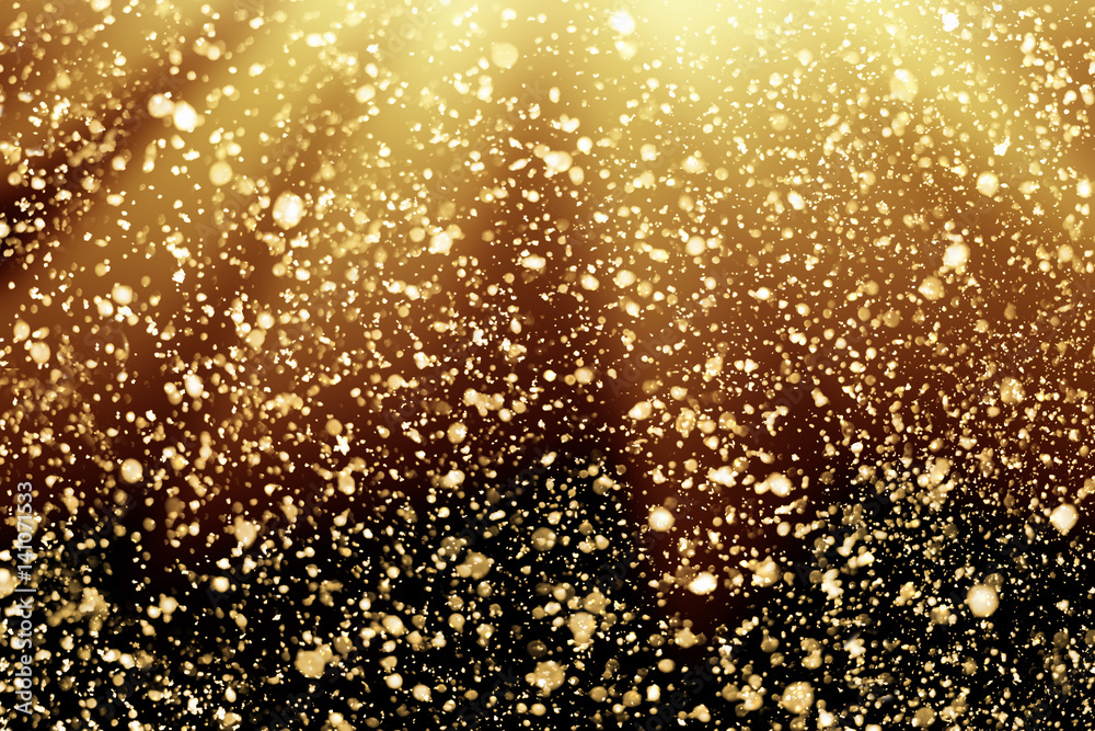 Golden rays and sparkles or glitter lights. Merry Christmas festive black background.defocused circle bokeh or particles
