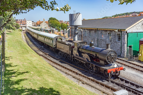 Steam train and carriages at Swanage railway station photo