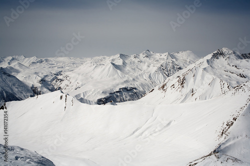 Winter snowy mountains and blue sky. Caucasus Mountains, Georgia, ski resort Gudauri