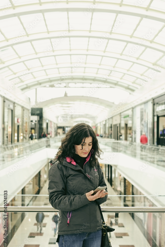 Woman in mall looking phone