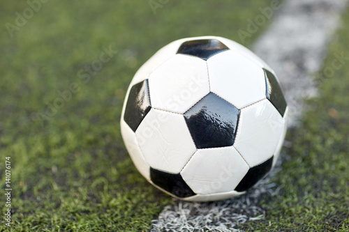 soccer ball on football field marking line