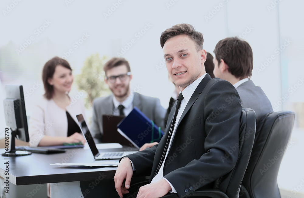 young employee in the workplace and the business team in the bac young employee in the workplace and the business team in the bac