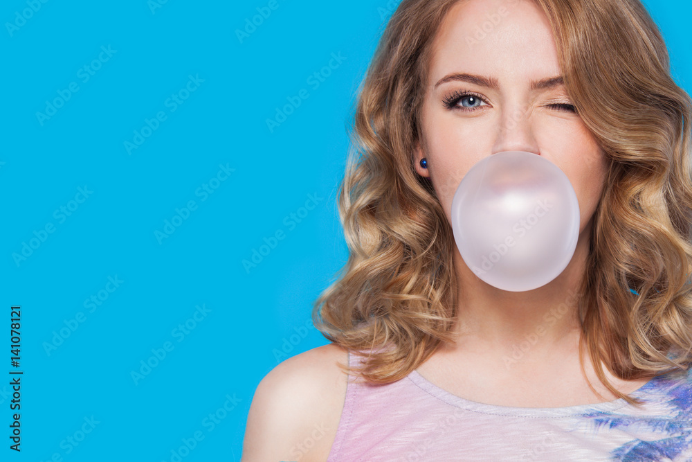 young pretty teenager girl emotional posing on blue background, fashion lifestyle people concept young pretty teenager girl emotional posing on blue background, fashion lifestyle people concept