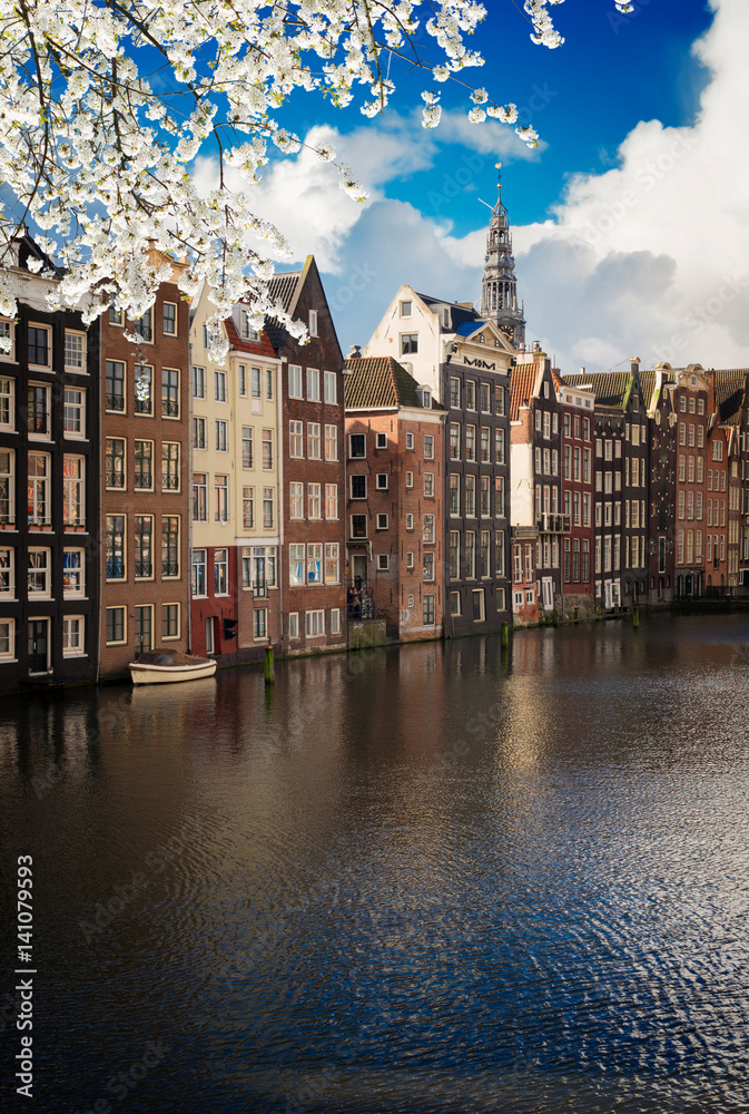 Typical dutch houses over canal at sunny day, Amsterdam at spring, Netherlands