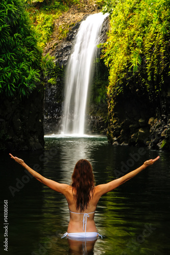 Young woman in bikini standing at Wainibau Waterfall on Taveuni Island, Fiji