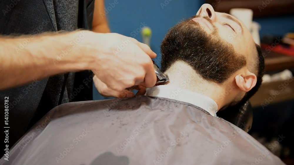 Hairdresser cuts beard to man Hairdresser cuts beard to man