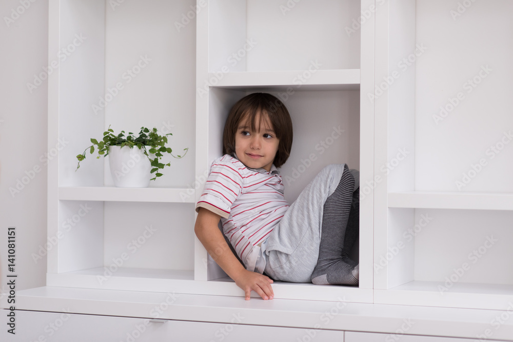 young boy posing on a shelf young boy posing on a shelf