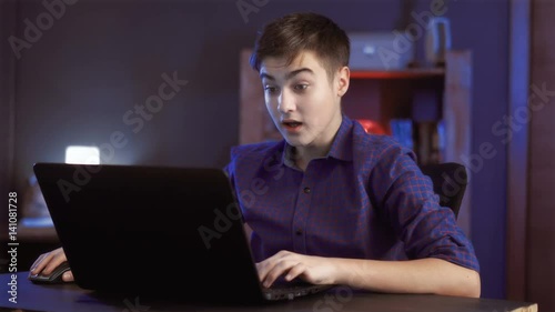 boy with the laptop works and learns