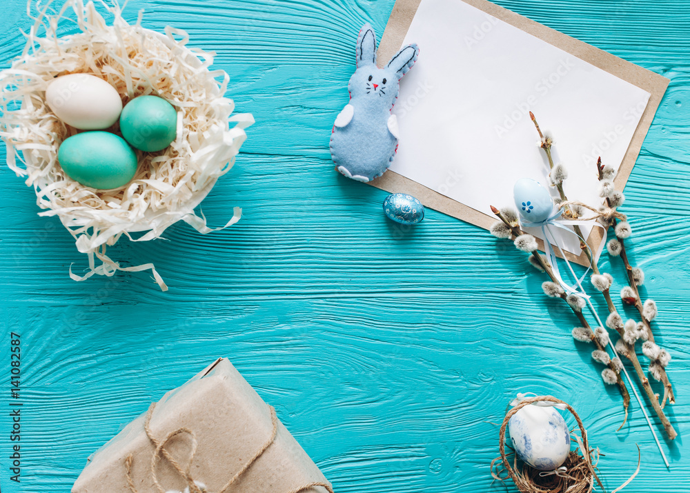 Naklejka premium Easter concept. greeting card, eggs and present on a blue background