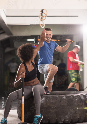 Quadro su tela multiethnic couple after workout with hammer