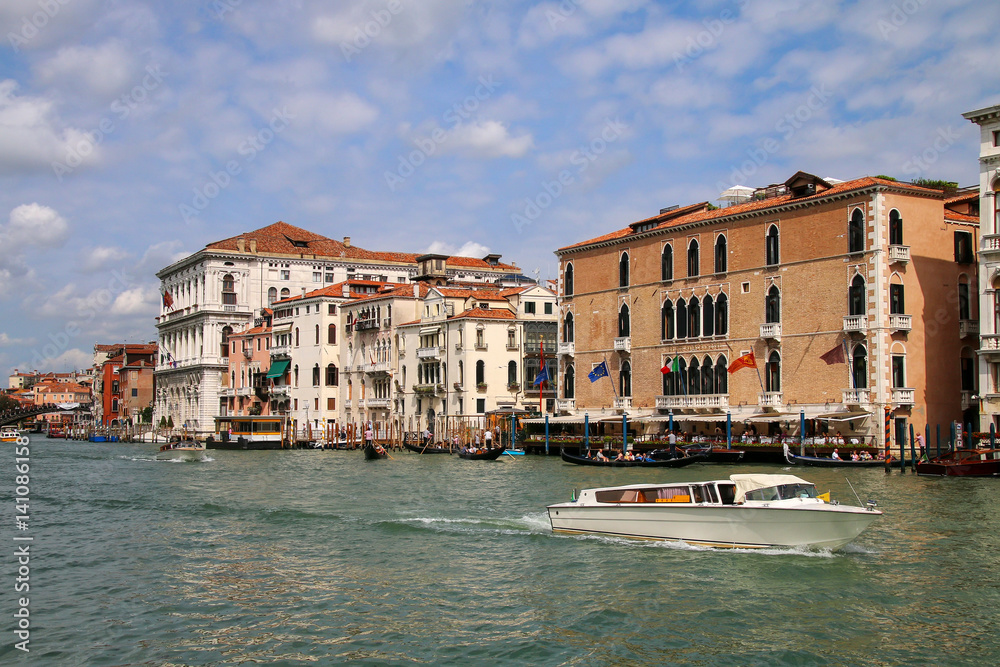 View of Grand Canal with houses and motorboats in Venice, Italy