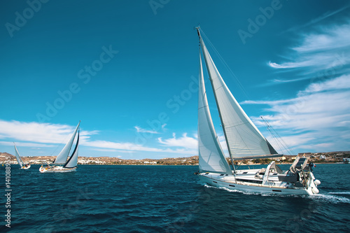 Luxury yachts at regatta. Sailing through the waves at the Aegean Sea.