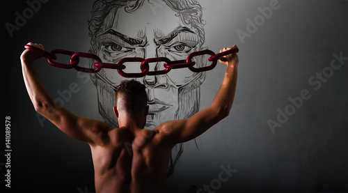Fototapeta Naklejka Na Ścianę i Meble -  One young man in a black chain raises above his head. The concept of freedom, or sports.