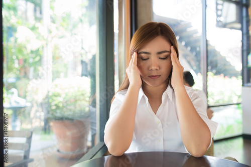 Woman has head ache at coffee shop Free Download Woman has head ache at coffee shop - GFXLoad
