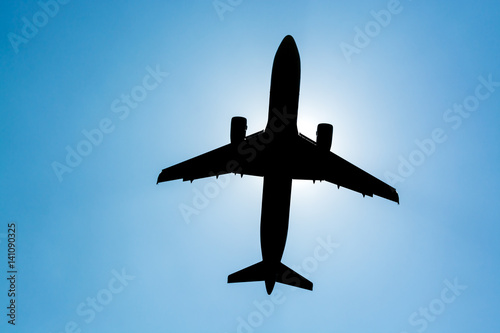 silhouette airplane with blue sky.