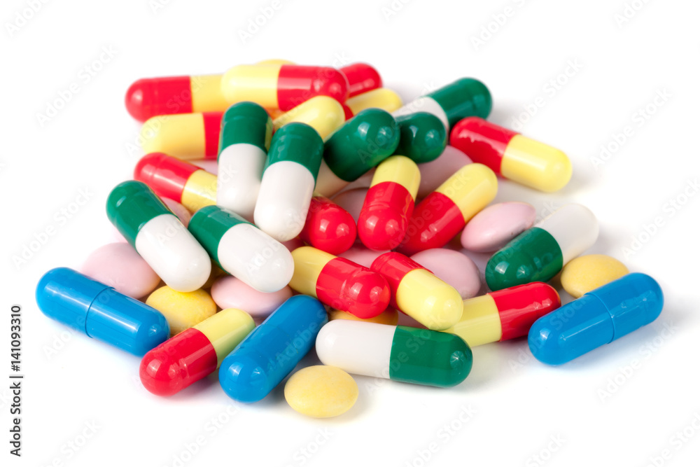 pile of colorful pills isolated on white background
