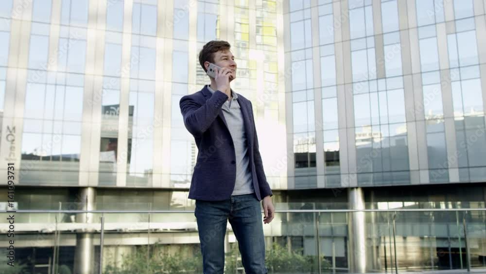 young businessman talking by mobile in city young businessman talking by mobile in city