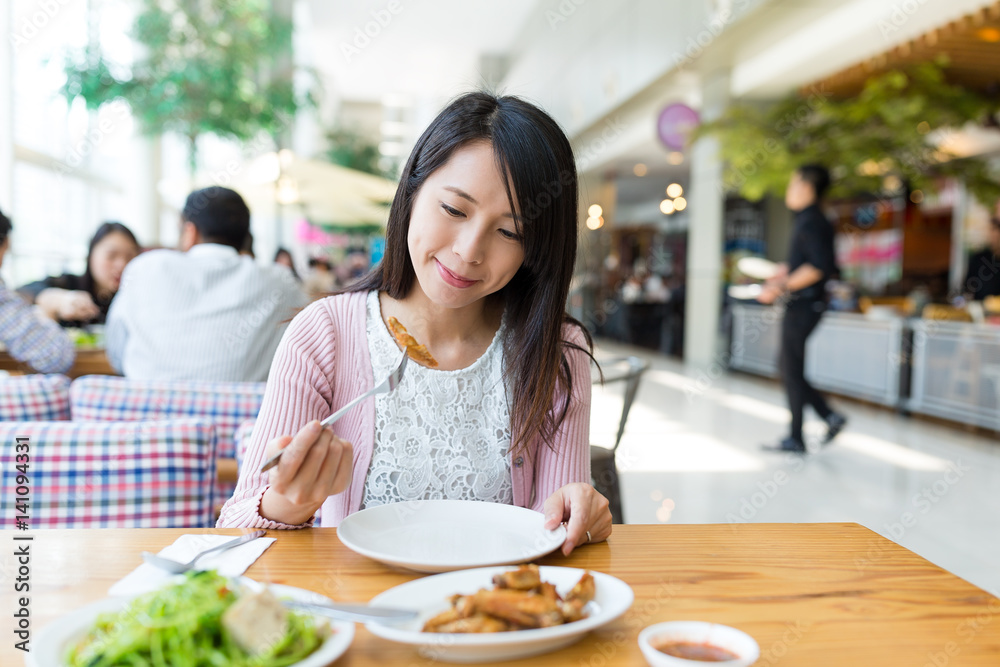 Woman enjoy her meal at restaurant