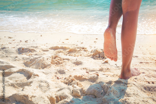 Leisure in summer - Beautiful leg of sexy women tan. relax on sandy tropical beach. vintage color styles © jakkapan