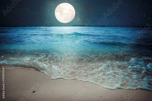 Beautiful fantasy tropical beach with star and full moon in night skies - imagine style artwork with vintage color tone
