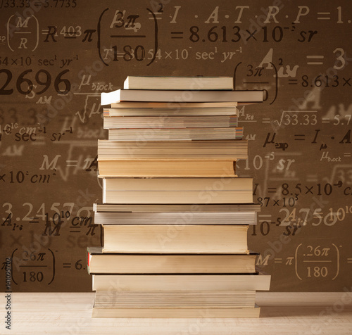 Books on vintage background with math formulas