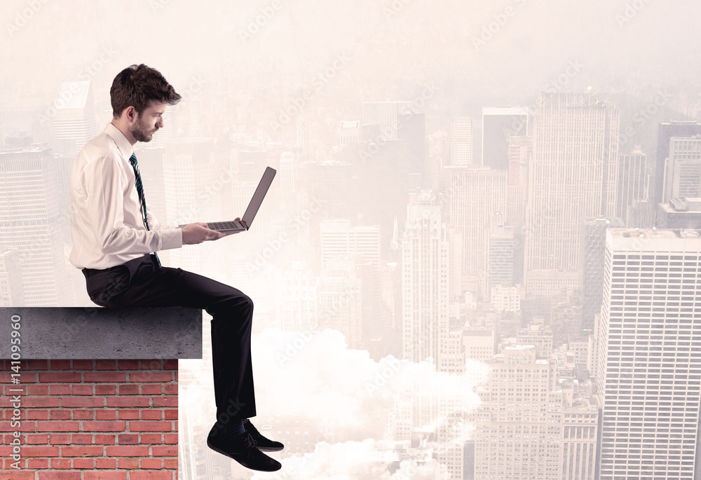 Office worker sitting on rooftop in city Office worker sitting on rooftop in city