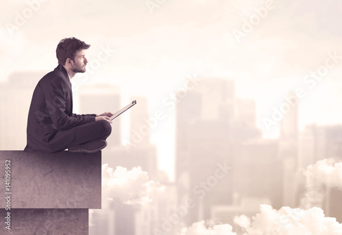 Peaceful sales guy sitting on roof top © ra2 studio