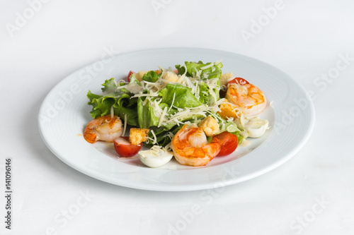 Plate of salad on white background